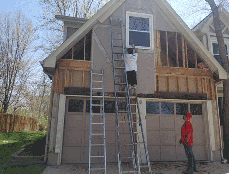 siding company in overland park ks installing new siding on a large house